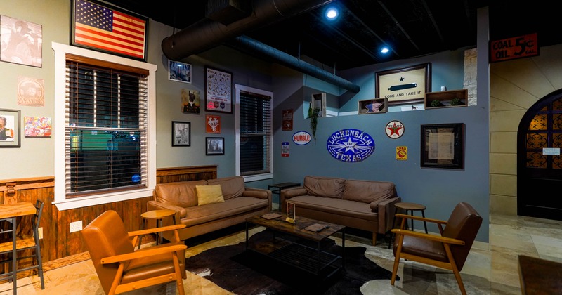 Cozy lounge area with leather sofas, Americana decor, and vintage signs