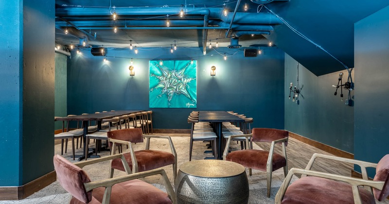 Interior, upstairs dining area, long table setups, painting and wall lamps, lanterns on the ceiling