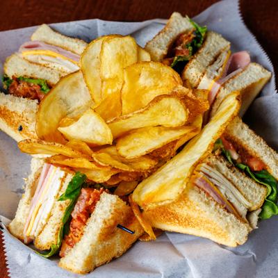 King club sandwich served with potato chips.