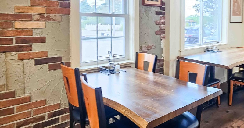 Interior, wooden table and chairs next  to the window