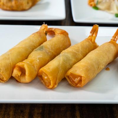 Thai shrimp rolls on a white plate.