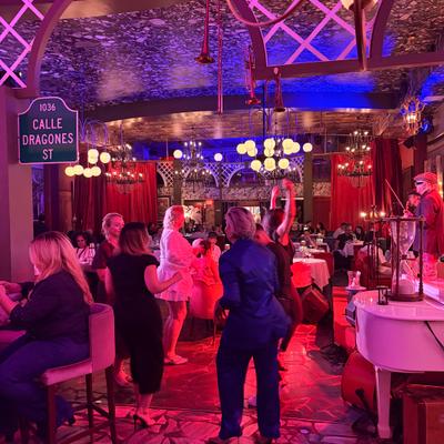 People dancing on the dance floor while the band is playing.