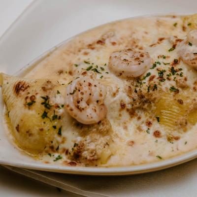 Cheese-stuffed shells topped with shrimp and crab meat with a white wine cream sauce.