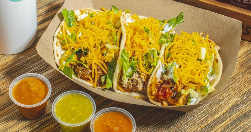 Tacos with three different types of salsa