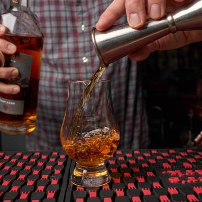 Hands preparing a drink.