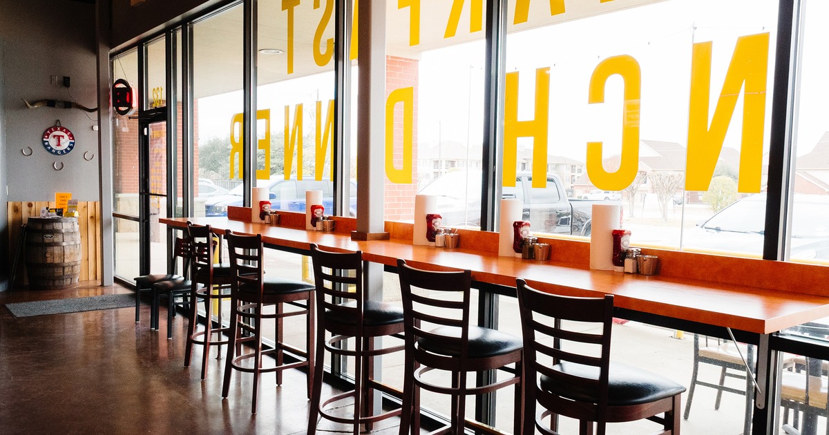 Counter seating with high stools along the window