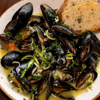 Mussels, sauteed with garlic, leaks, white wine, and served with toasted bread.