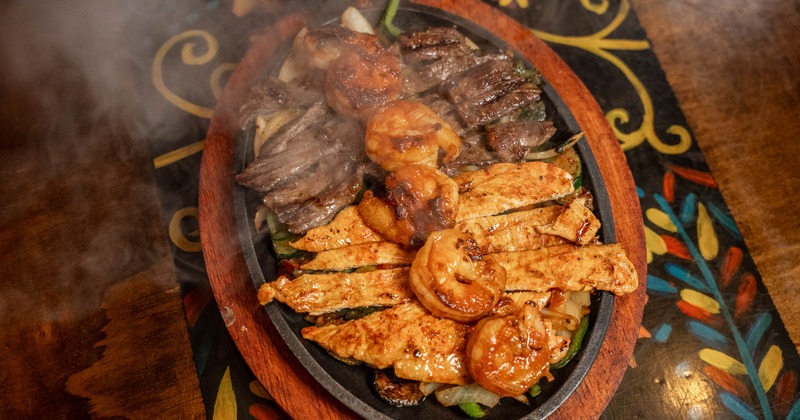 Texas fajitas with shrimp, chicken, and steak