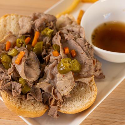 Italian Beef sandwich, with peppers, and broth on the side.