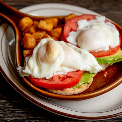 California Benedict with poached eggs, avocado, tomato and potatoes.