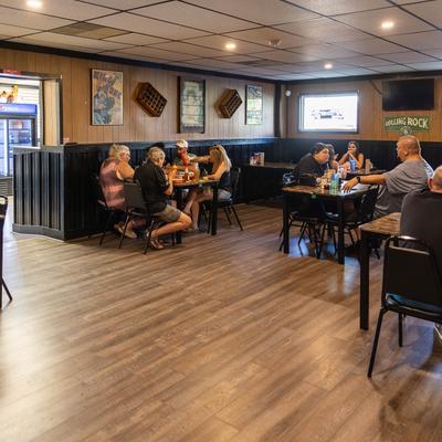 People dining at tables in a casual restaurant.