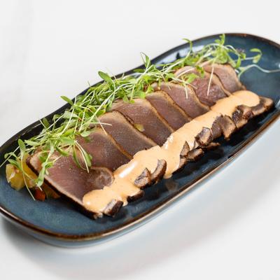 Seared and sliced tuna dish, served.