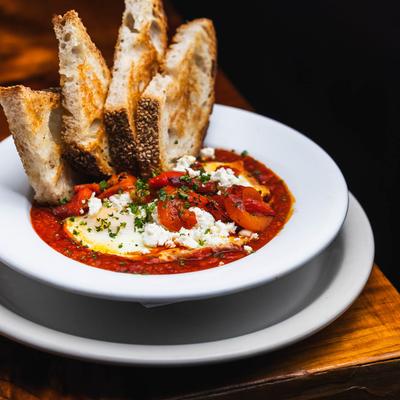 Shackshuka homemade slow tomatoes with herbs.