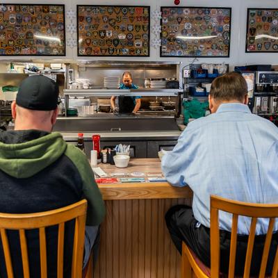 Customers sitting at the bar counter.