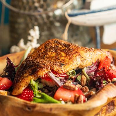Salad with blackened fish fillet, seasonal spring mix, fruits, nuts and feta.