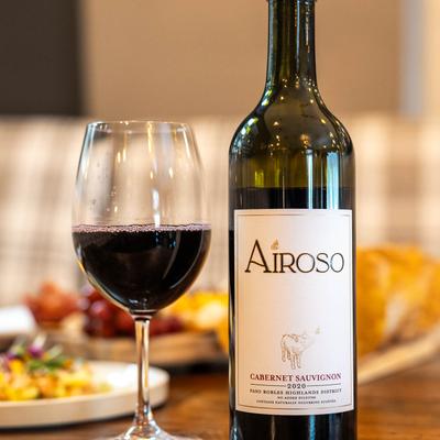 A bottle and glass of red wine.