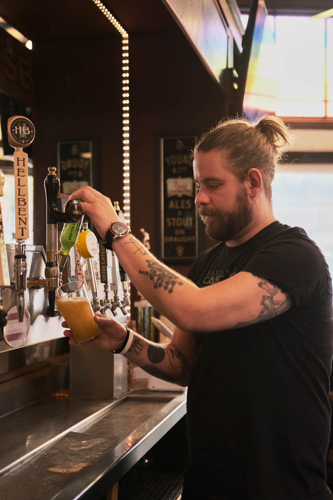 Bartender pouring beer from tap