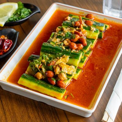 Spicy cucumber salad with peanuts in red chili oil.