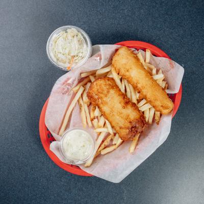 Fried mahi mahi fish served with fries and coleslaw.