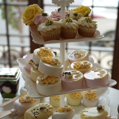 A two-tiered stand filled with assorted desserts for a special occasion.