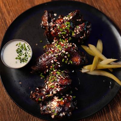 Coca Cola chicken wings served with pickle and Gorgonzola ranch.
