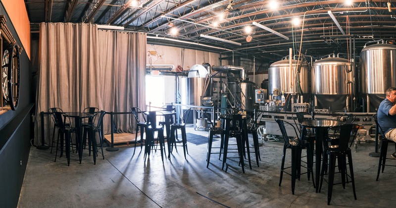 Interior, high tables and chairs, beer tanks in the back