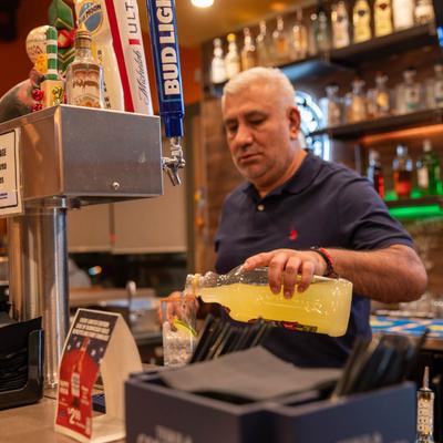 A bartender pouring drink.