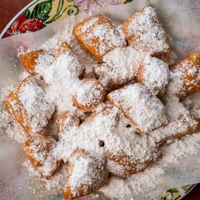 Deep-fried Italian pastries, dusted with powdered sugar.