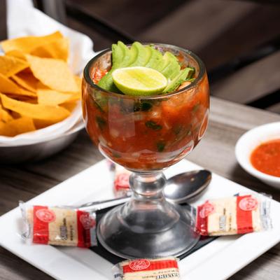Shrimp cocktail  side by side with chips and salsa.