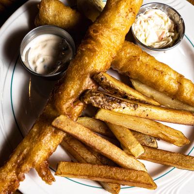 Fish and Chips served with coleslaw and tartar sauce.