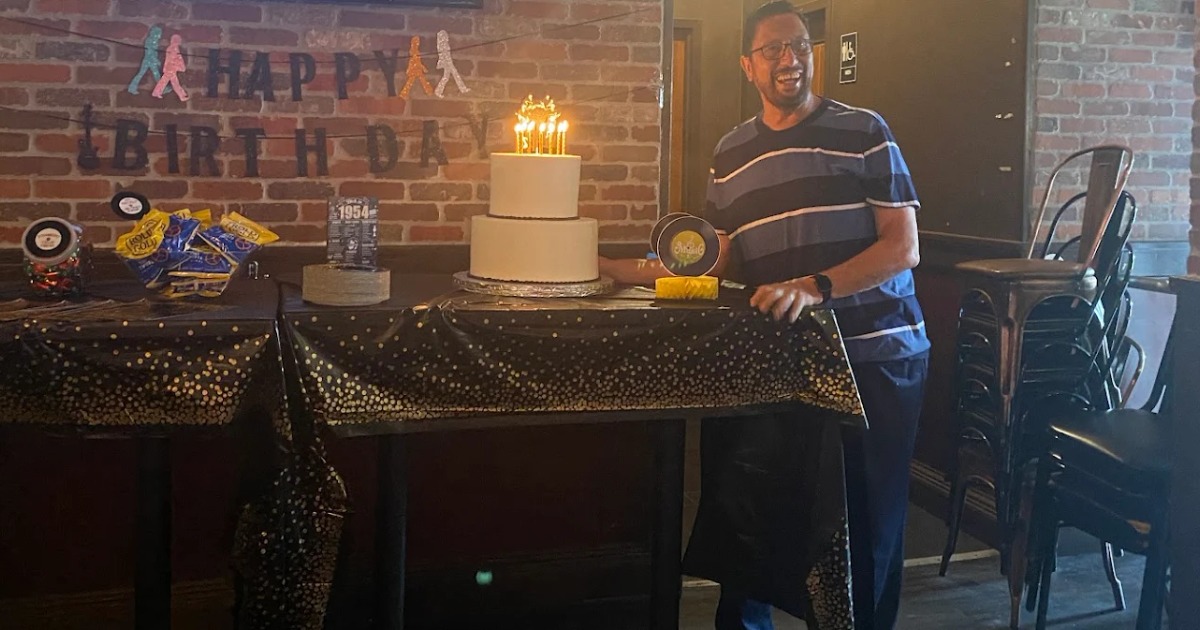 man with birthday cake at the best place for private parties in hoboken, new jersey