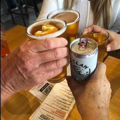 People making a toast with their drinks.