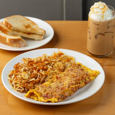 Omelet with hash browns, toast, and iced coffee.