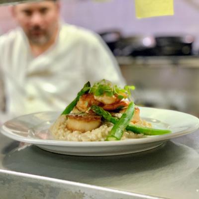 Kitchen shots, a plate of scallop risotto with asparagus.