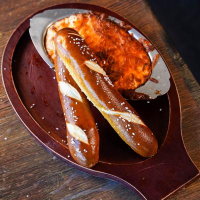 Crab dip served with pretzel sticks.