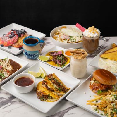 Assorted dishes and beverages displayed on table.