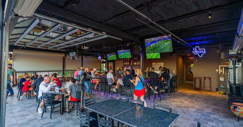 Exterior, bar, patio,  tv screens, tables, stools