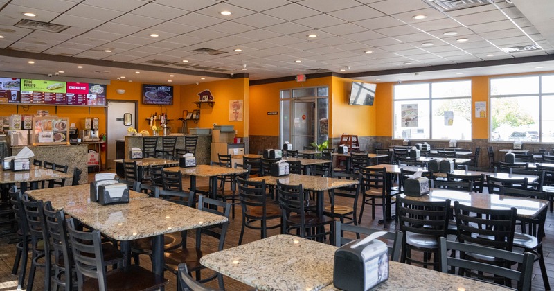 Interior, dining area, tables and seats ready for guests