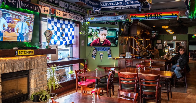 Interior, tables, chairs, sports memorabilia, bar behind