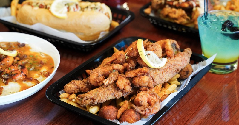Fried Salmon Strips served with a cocktail and other dishes