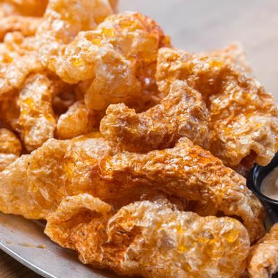 House fried pork rinds served with a dip.