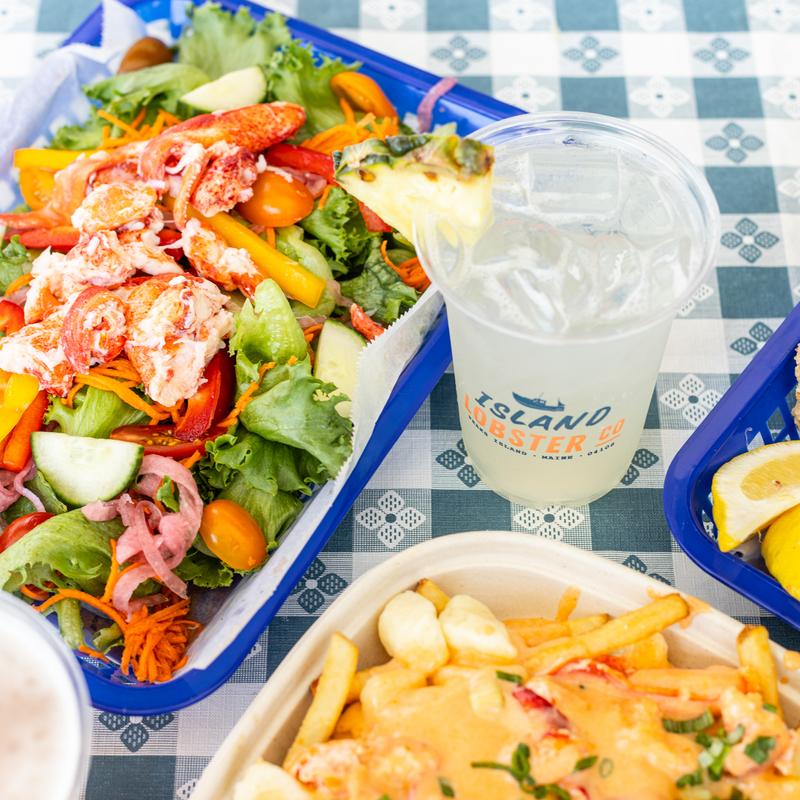 Garden Salad with lobster, Lobster poutine and fried clams plate, with drinks