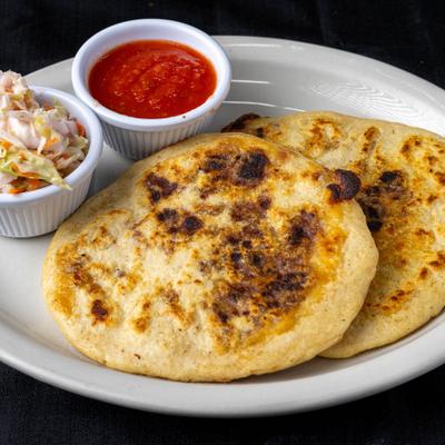Cornmeal griddle cakes served with coleslaw and tomato sauce.
