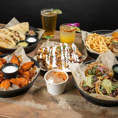Assortment of fishes and drinks from Taco Loco, spread on a table.