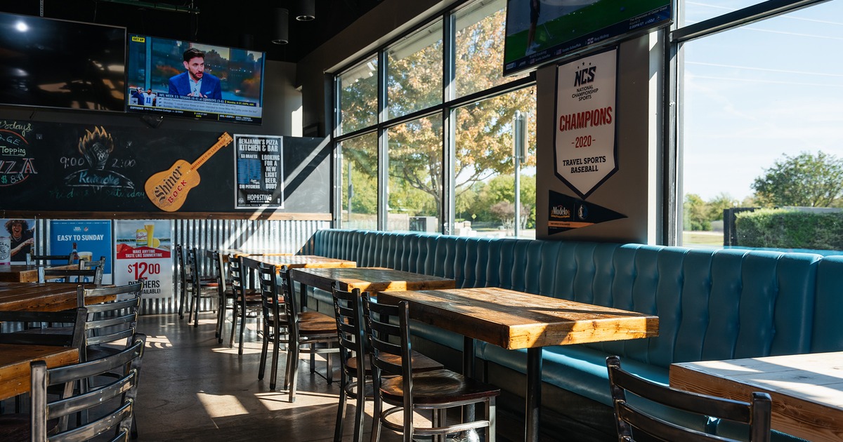 Cozy interior seating area, upholstered seating and lined-up tables