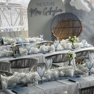 Decorated table set for a special occasion with cloud-themed decoration.