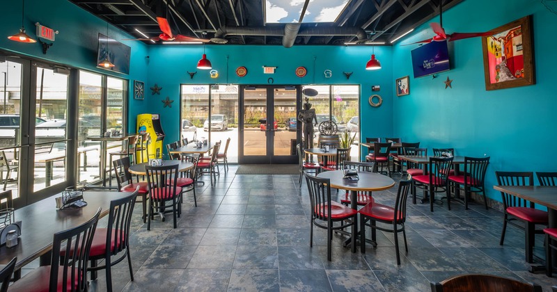 Interior, dining area, wooden top tables for three, four and six people, entrance