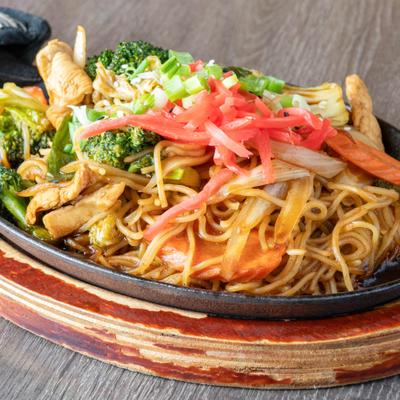 Yakisoba served with chicken and mixed vegetables.