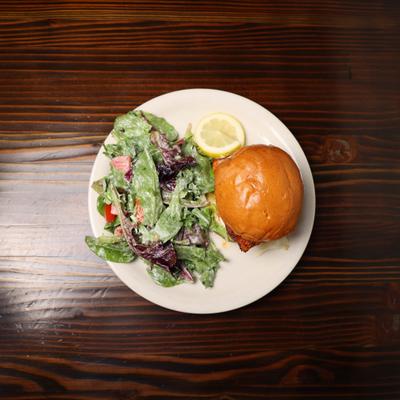 Grilled Chicken Sandwich on brioche bun  with side salad.