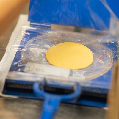 Tortilla being pressed.